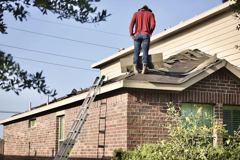 Professional roofer working on a residential roof in Jersey